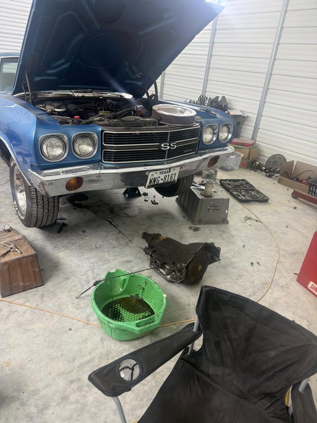 A blue Chevelle SS with the hood up inside the KND Performance shop