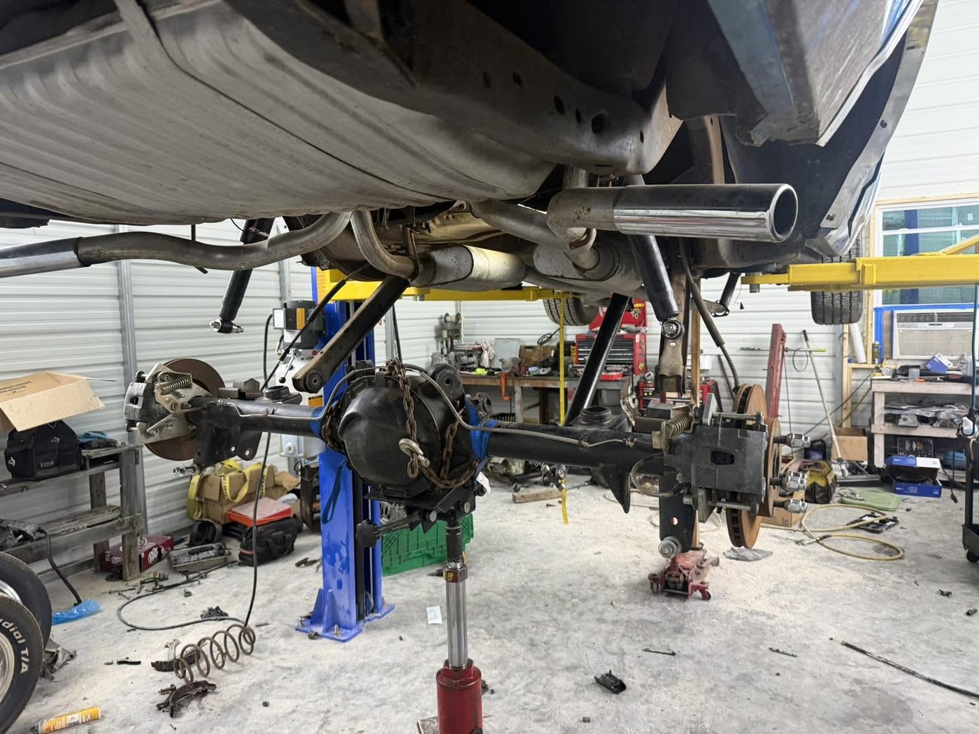 A vehicle on the lift with the rear suspension and axle apart